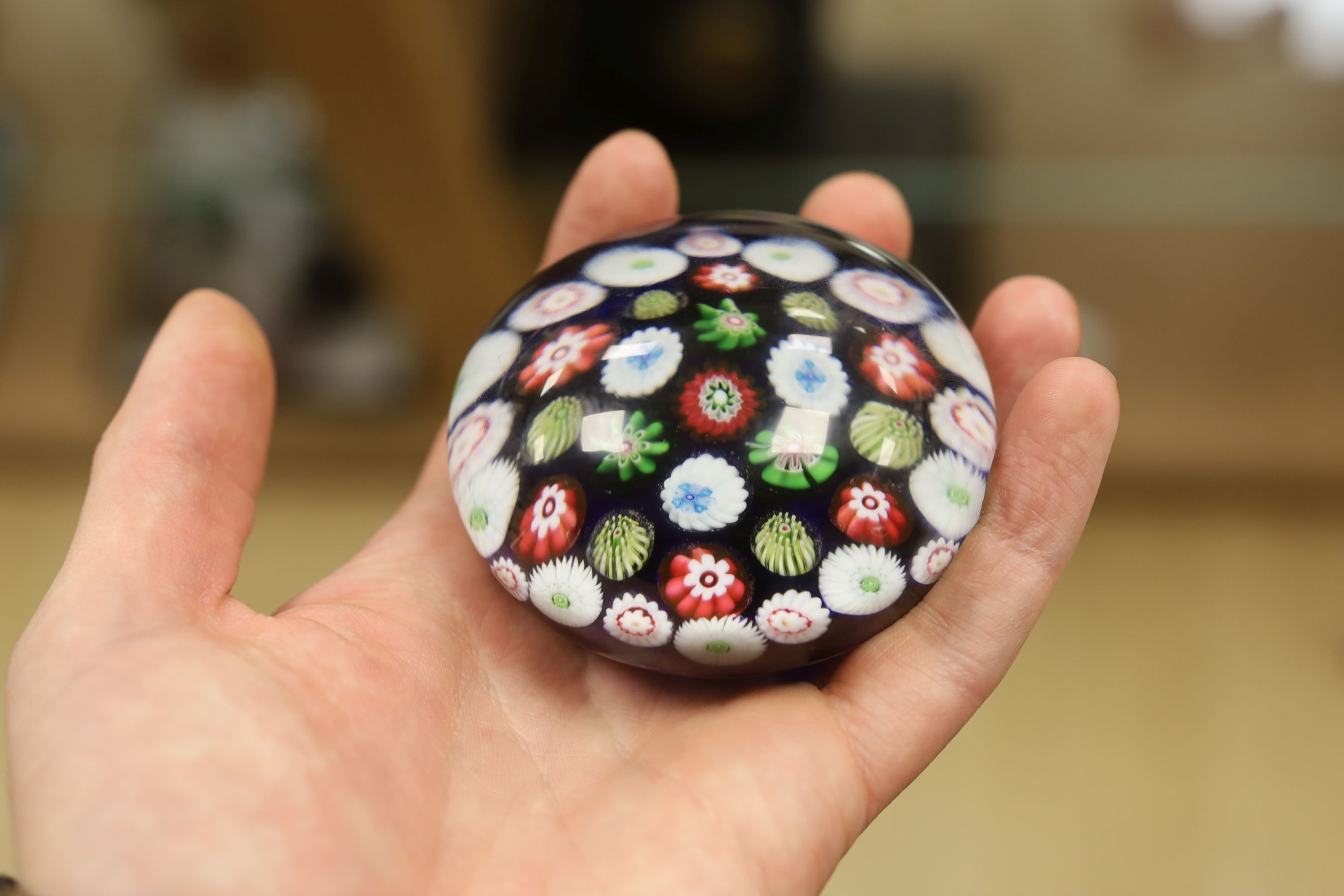 A Clichy translucent blue ground millefiori glass paperweight, 7cm in diameter